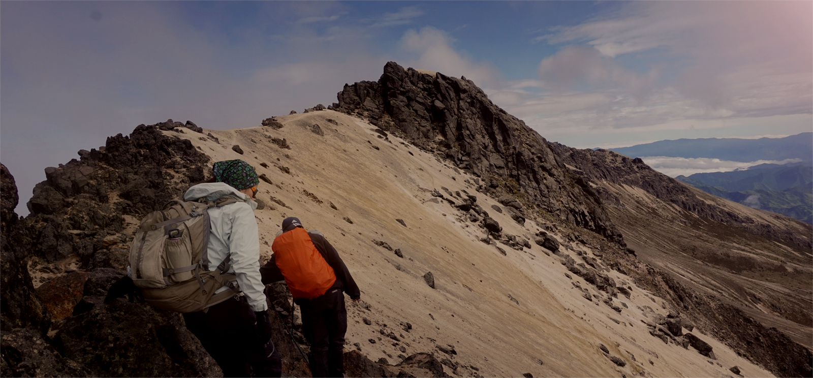 best trekking vacations: Hikers walking on a mountaintop.