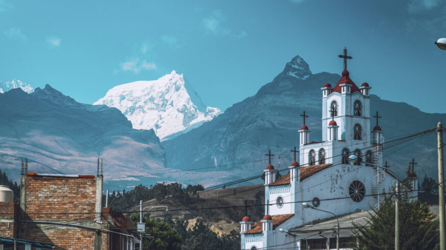 A church seen front of the Andes Mountains Cordillera Blanca in the city of Huaraz, Peru.