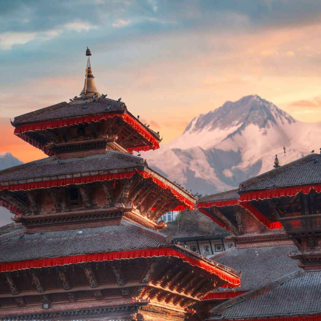 Nepal temple with Mountain behind: custom Nepal itinerary