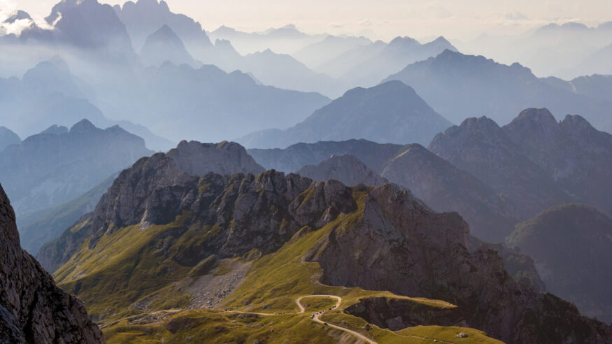 Mountain silhouettes in the Julian Alps, Slovenia, at sunset, in a warm late Summer day, as seen comming down from Mangart peak