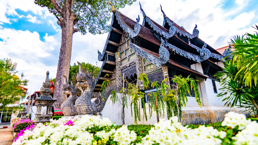 Vihara of Liang Pu Mun in Chiang Mai city, Thailand. Old ancient religion building, spiritual place. Big snake statue before temple. House is placed near Wat Chedi Luang temple.