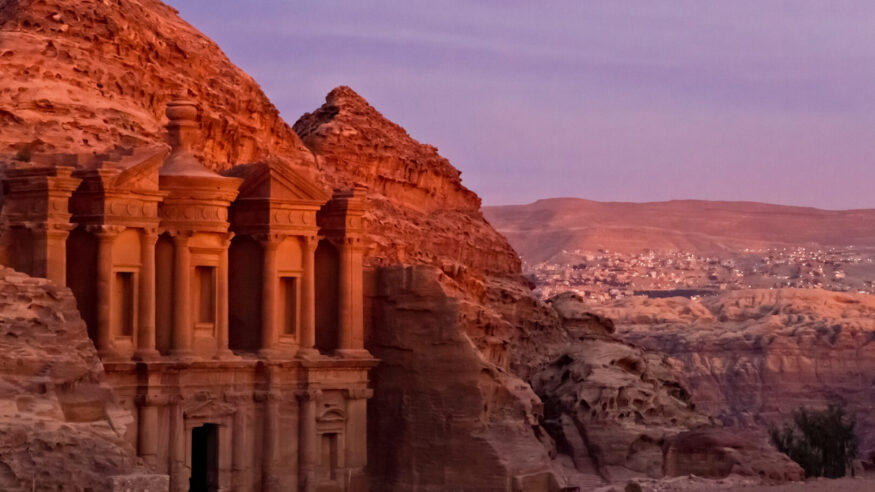 The famous Ad Deir, often also refered to as Monastery, in the ancient nabbatean city of Petra in Jordan at sunset with a view to the city of Wadi Musa.