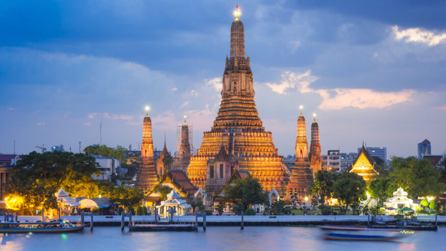 Wat Arun temple gold lighting after sunset with blue sky