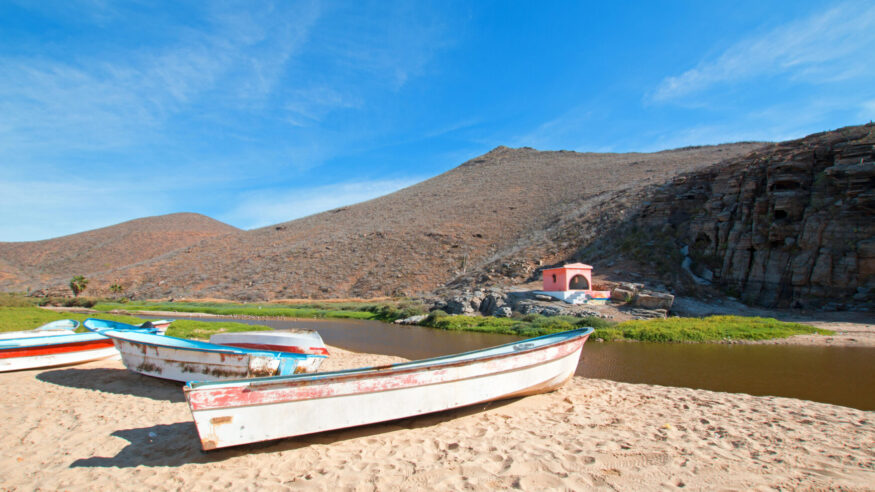 Small fishing boats / pongas at Punta Lobos beach on the coast of Baja California Mexico BCS
