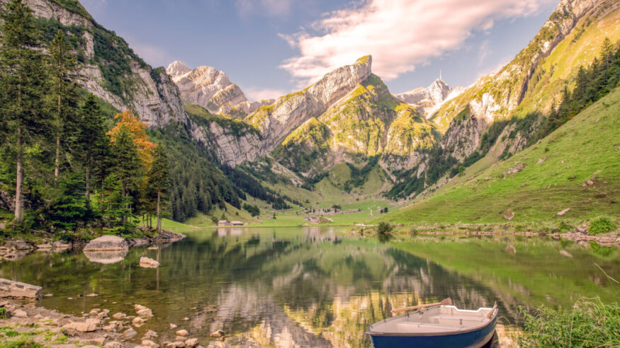 Seealpsee in the Swiss Alps with a boat and a view of the Säntis