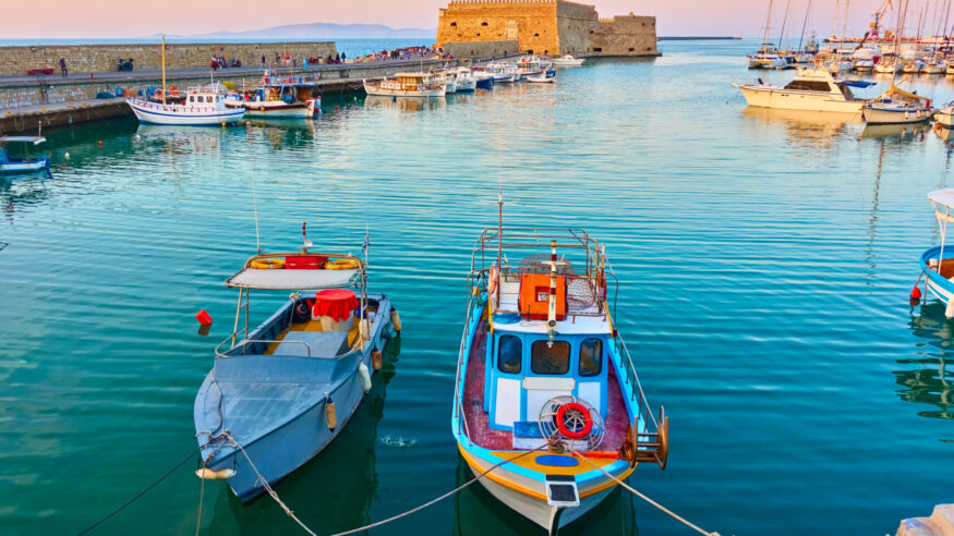 Fishing boats in the harbour near the Venetian Fortress in Heraklion, Crete, Greece